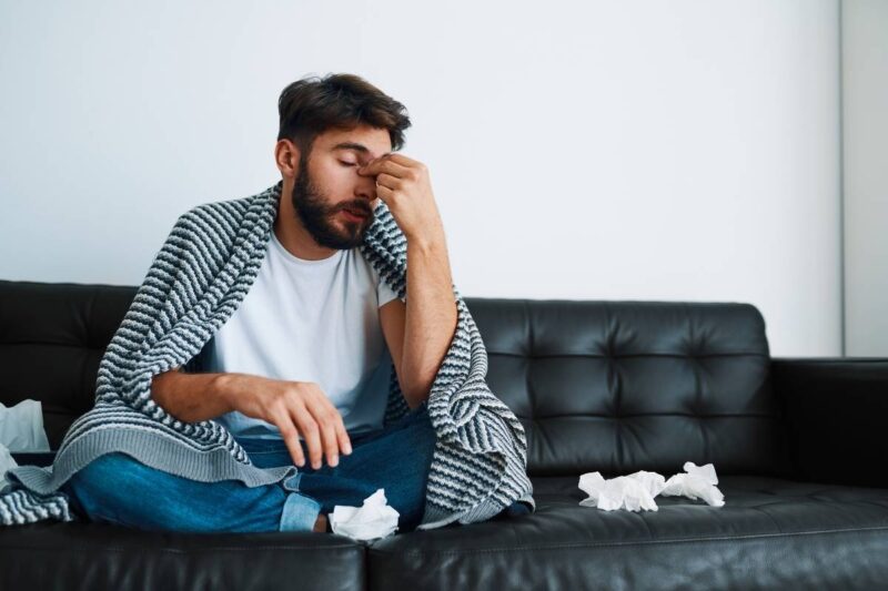 Man having allergies from neglecting HVAC service