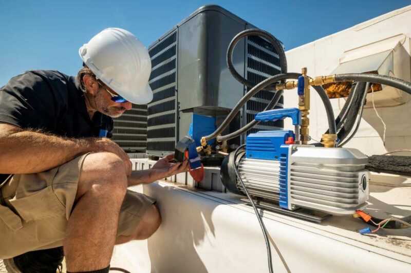 Technician performing air conidition repair